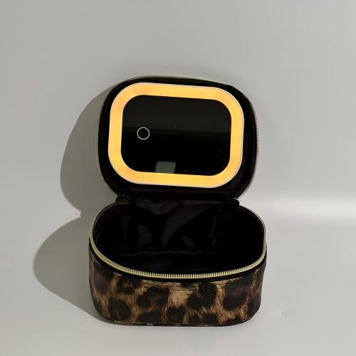 Black and gold jewelry box with open lid on a gray background
