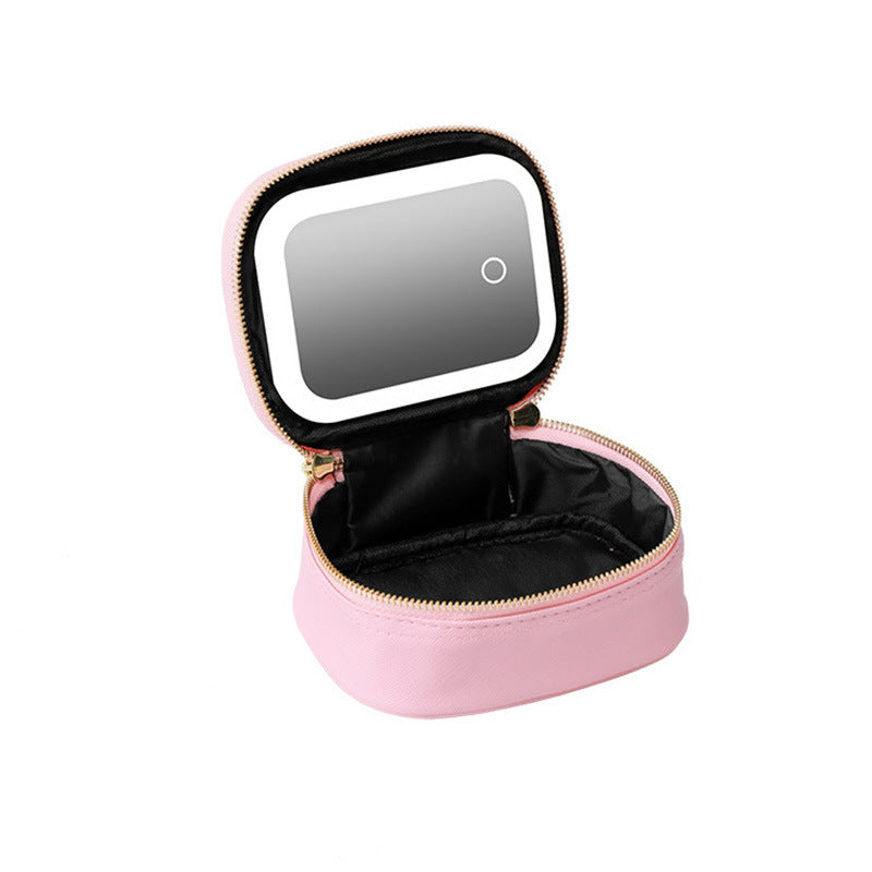 Pink makeup case with a mirror on a white background